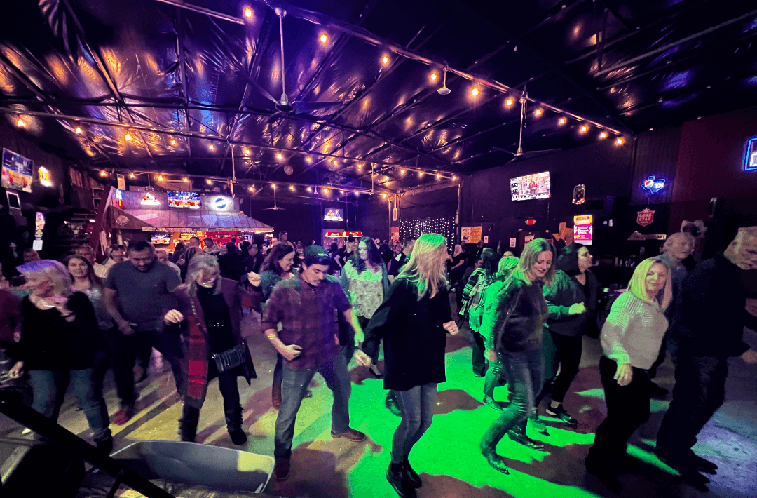 Packed crowd under green lighting