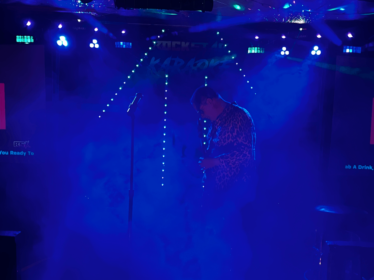 Performer with Rockstar Axe in blue haze
