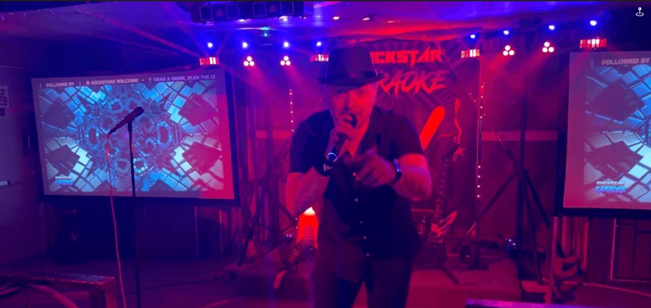 JC performing at a Rockstar Karaoke show